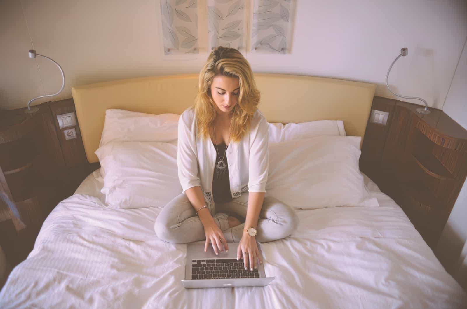 woman working bed laptop typing female enlarged