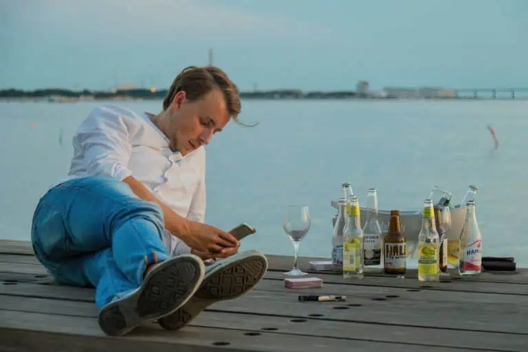 person using their phone while drinking upscaled