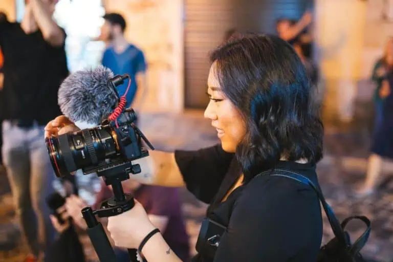 woman filming with a camera