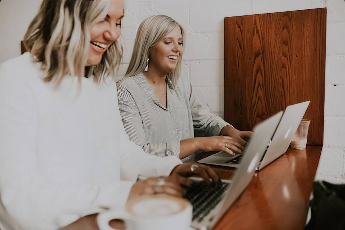 Tips for Getting the Most Out of Your Enterprise SEO Software 3 two women using laptops and laughing