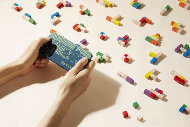 Woman playing PITAKA Pixel Game on iphone