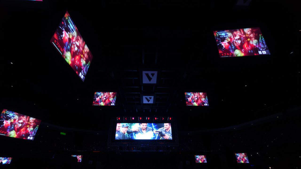 An esports arena with bright Dota 2 screens shows competitive gaming energy.