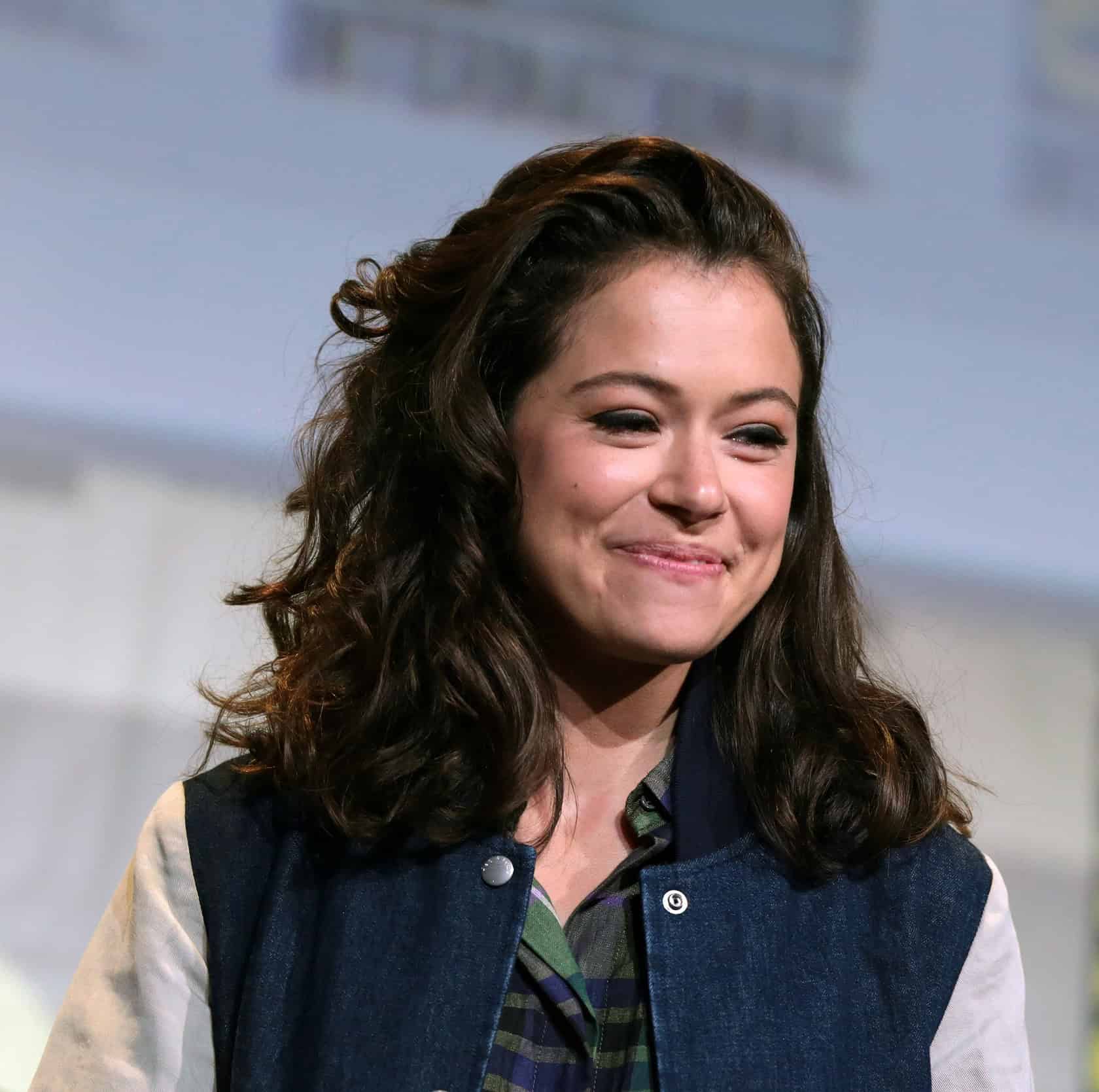 A woman in her 30s wearing authentic costumes, expressing passion for theater and geek culture. Tatiana Maslany