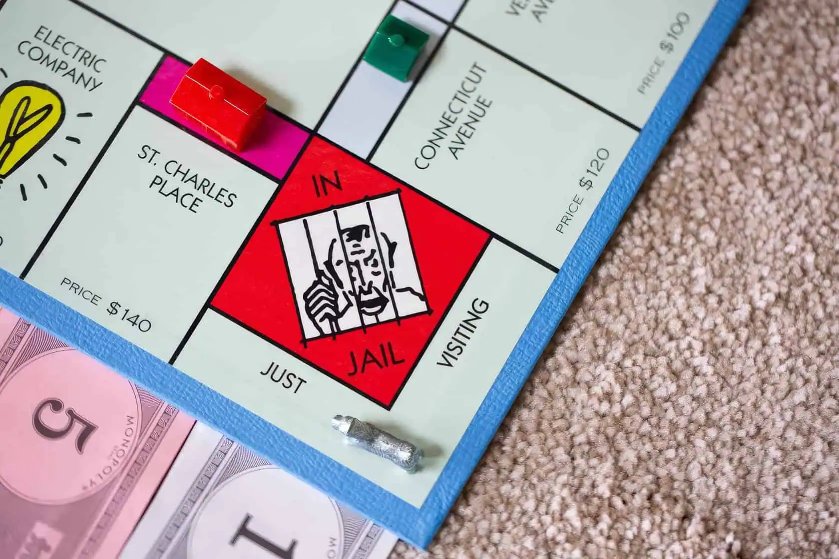 A family of four engages in a game of Monopoly at their cozy living room coffee table. How To Get Out Of Jail In Monopoly 3