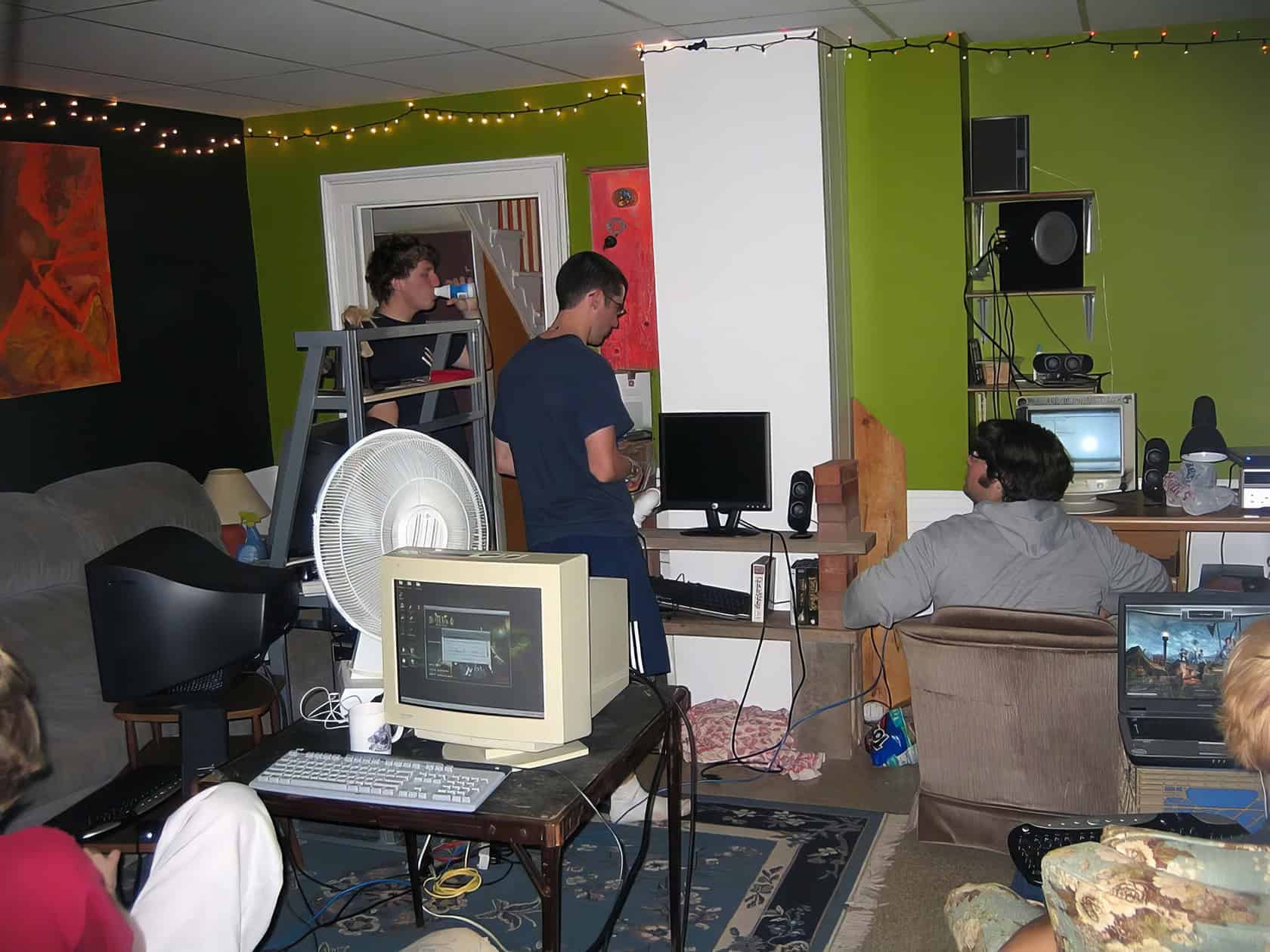 A young man enjoys a relaxed gaming session in a cozy room filled with peripherals and snacks. What Do You Need for LAN Party Fun 2