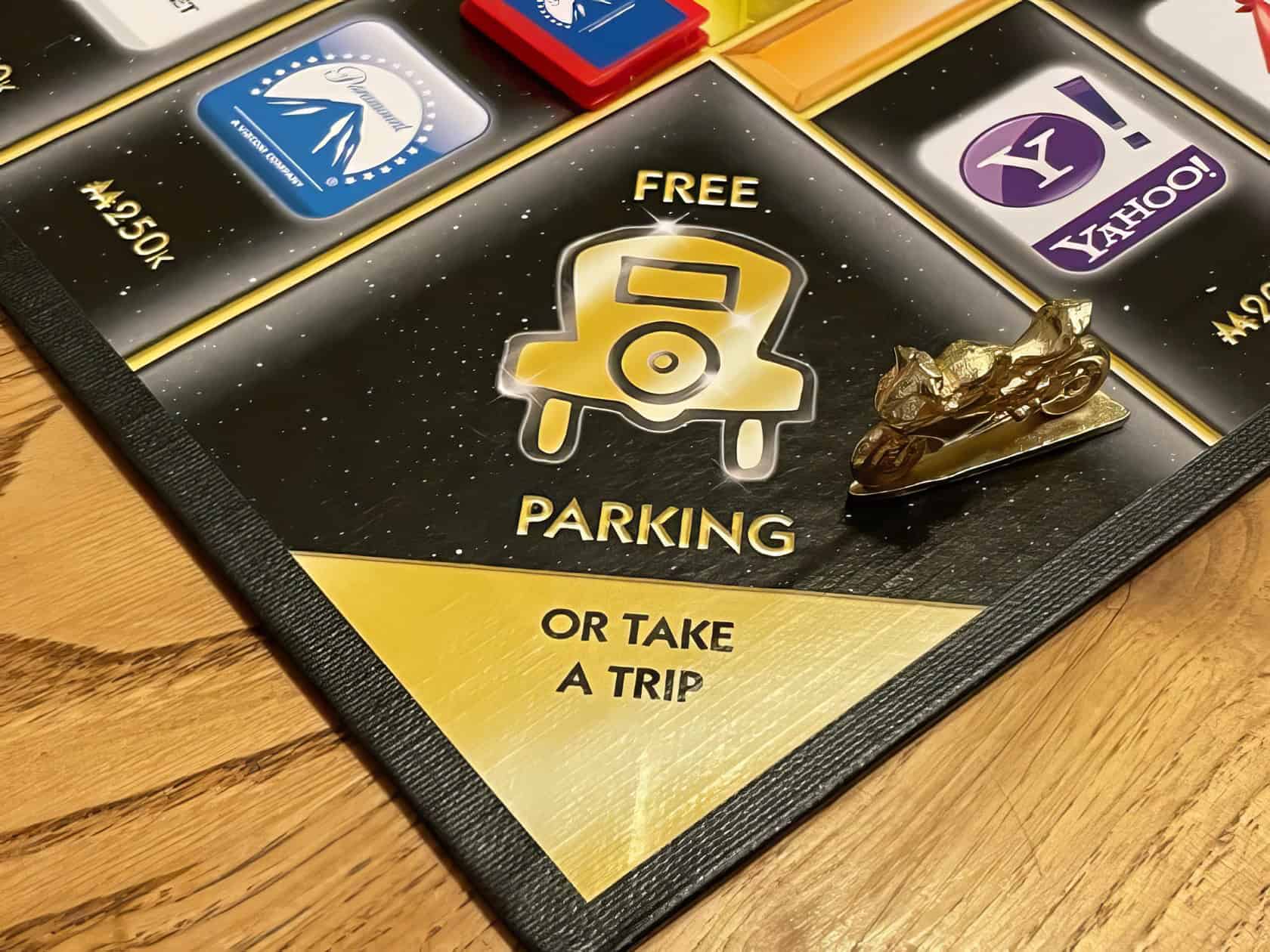 Four friends gather around a vintage table, enjoying a game of Monopoly in a cozy, inviting living room. What Does Free Parking Mean In Monopoly 3