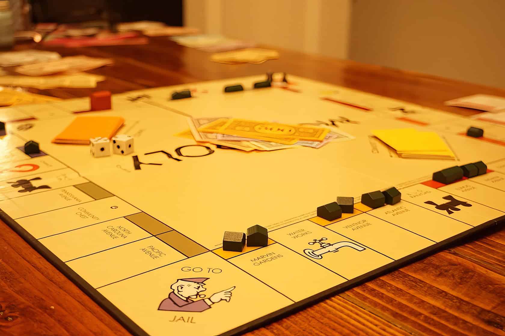 A family enjoys a cozy game of Monopoly around a polished oak table in their living room. When Can You Buy Houses in Monopoly 3