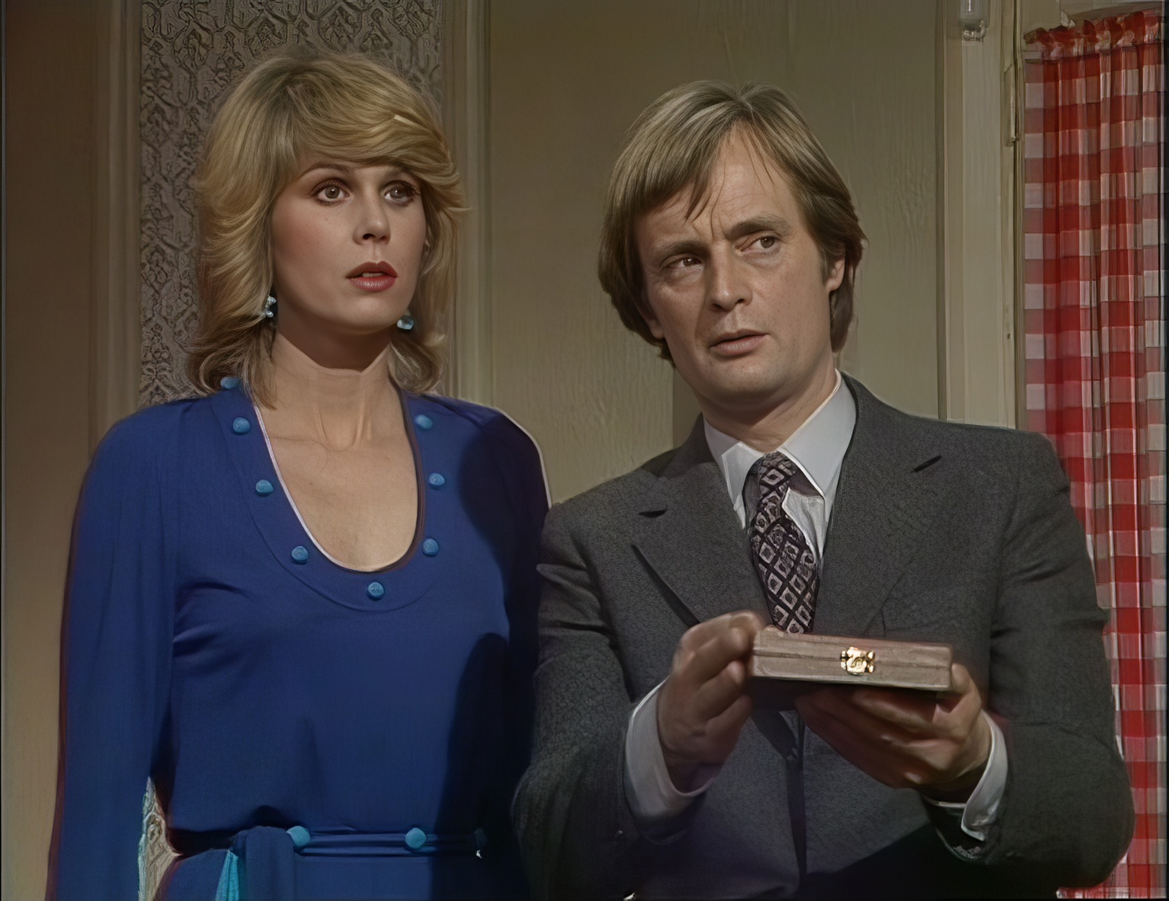 Two people in a small, cluttered room, one adjusting a thermostat while the other appears relaxed. Sapphire Steel TV Show 5