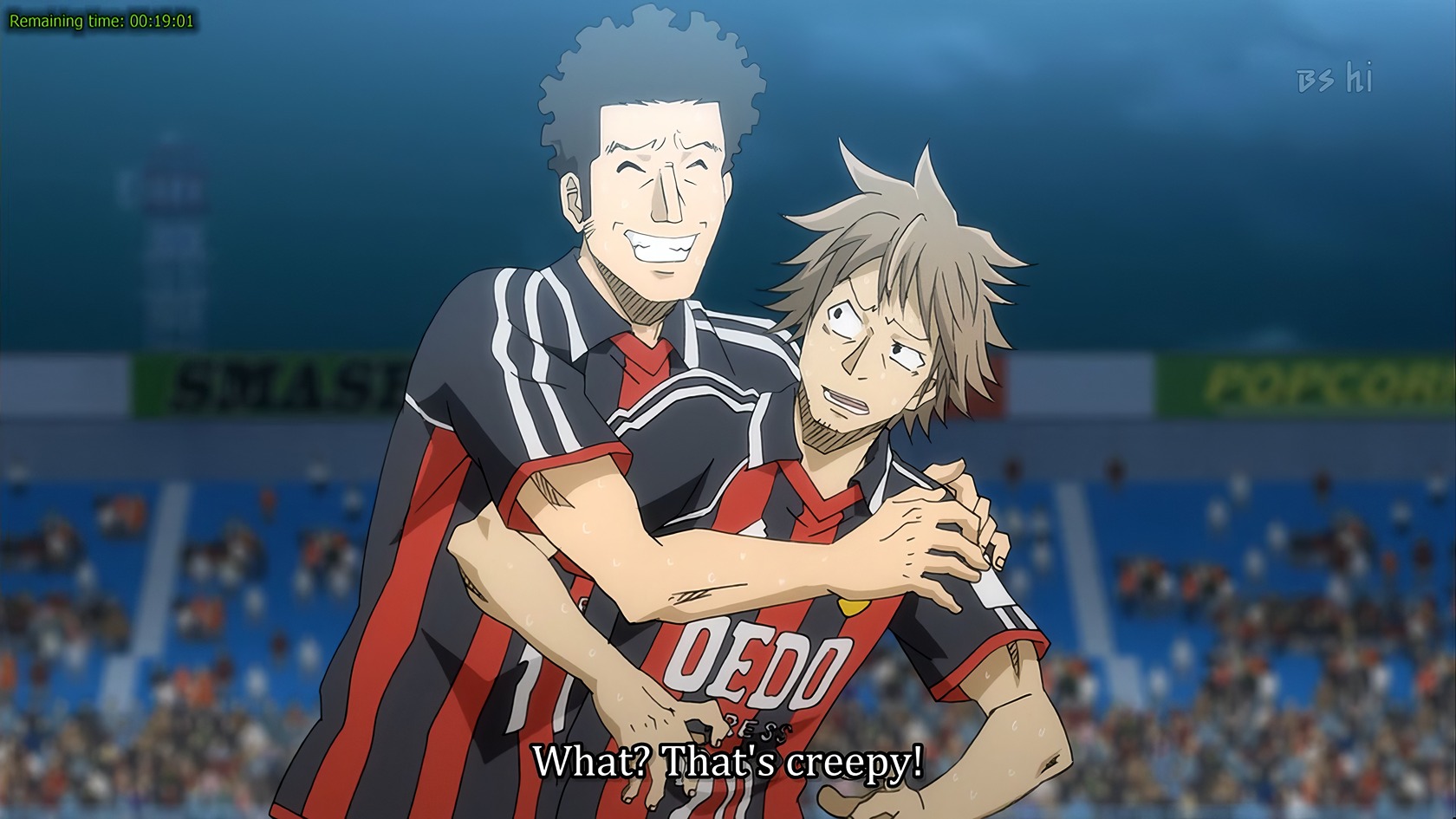 Anime About Soccer: 10 Winning Picks to Watch Now 3 - Vibrant anime scene of two soccer players in black and red jerseys celebrating on the field during a match.