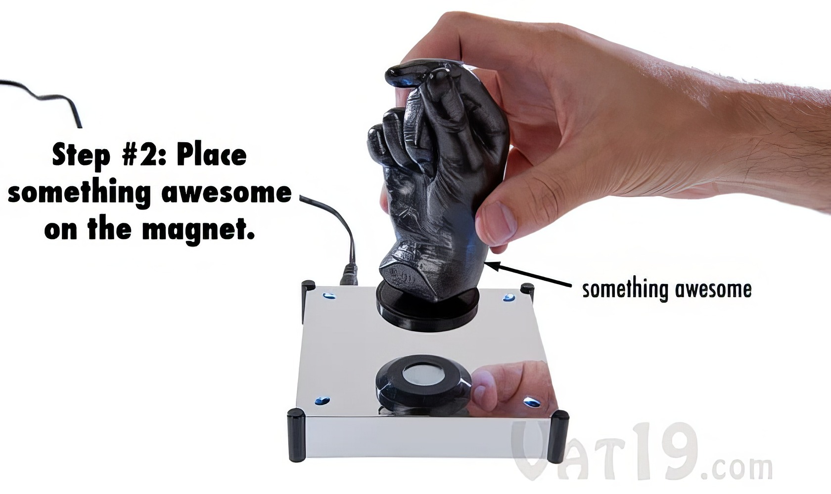 Levitron Revolution Ez Float: The Magical Floating Device 5 Hand placing a small object on a magnet atop a flat surface, illustrating a fun geeky experiment or tutorial.