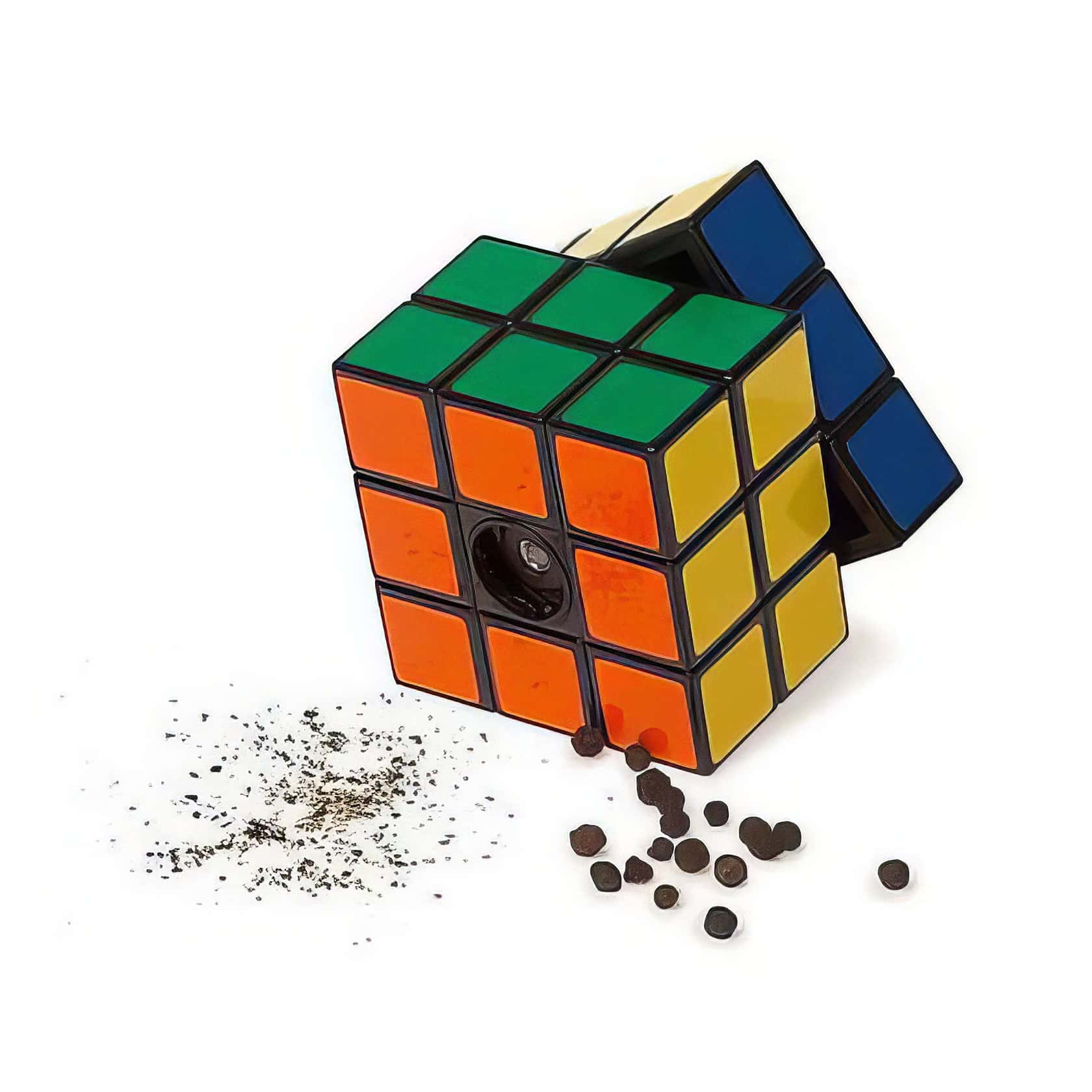 Colorful Rubik's Cube with spilled black pepper and seeds on white background, illustrating a playful, puzzle-solving theme relevant to tech and gaming enthusiasts.
