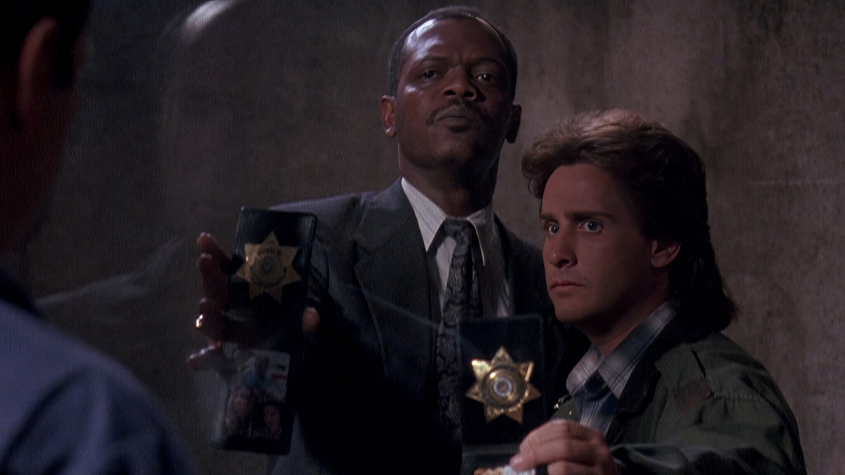 The Legacy of Loaded Weapon 2: A Deep Dive Into the Unmade Sequel 4 Handcuffed police officers interrogating a suspect in a dramatic scene from the movie.
