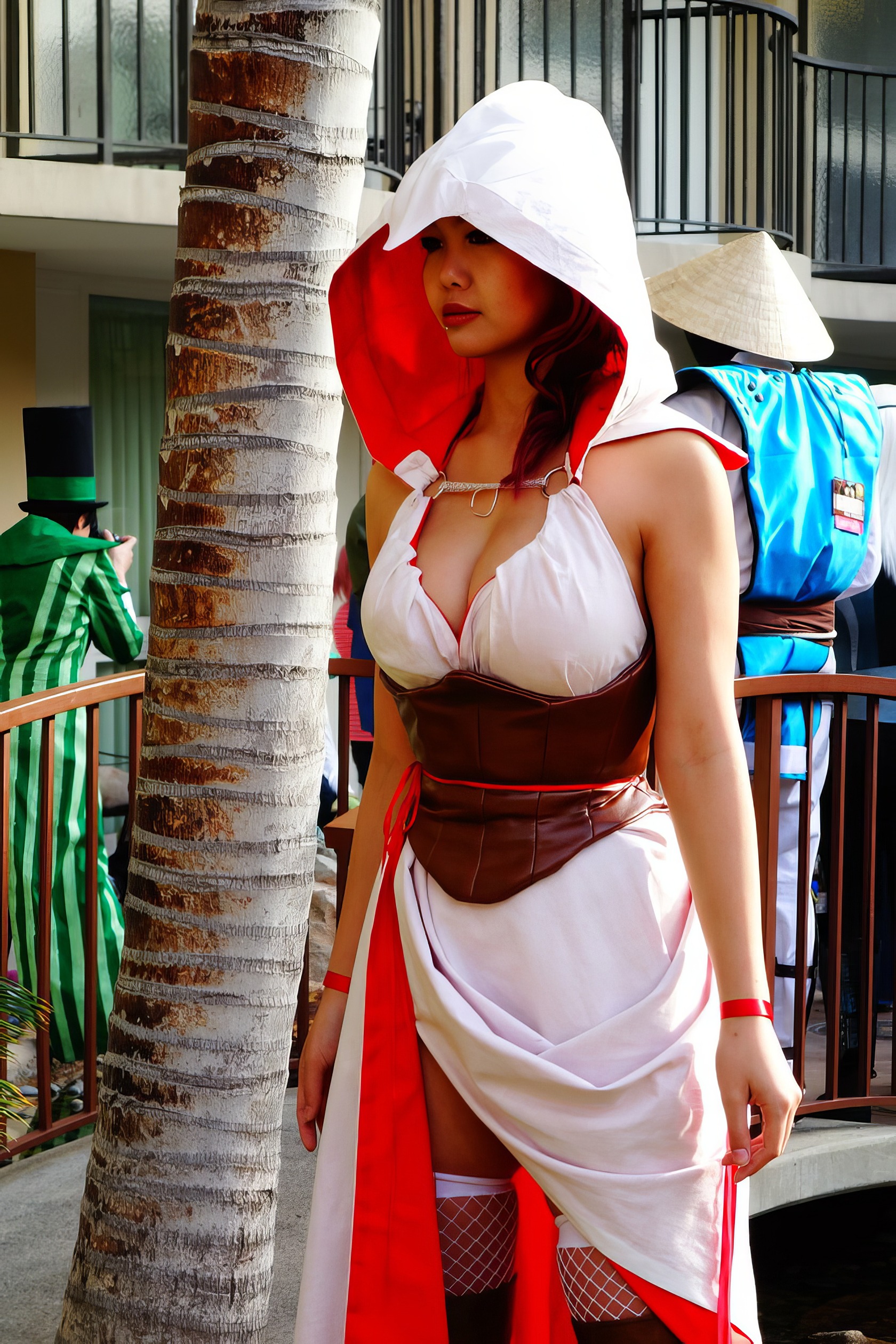 Assassin's Creed Hot Cosplay: 20+ Character Costumes & DIY Tips 9 Hooded female cosplay character wearing a white and red costume with fishnet stockings, standing outdoors next to a tree at a convention or event.