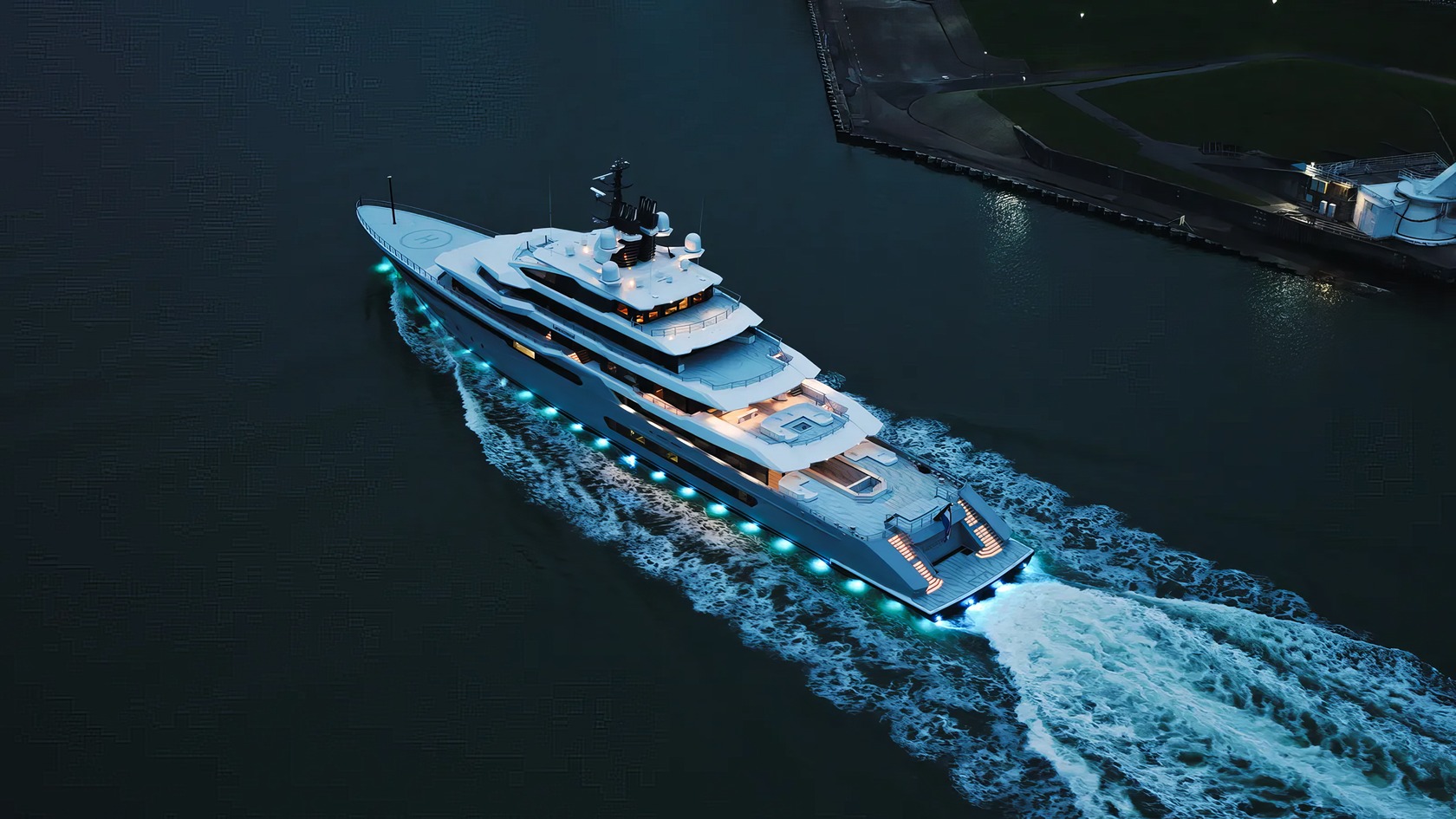 Gabe Newell's Superyacht: 5 Bold Ideas Behind Leviathan 8 Luxurious white yacht cruising on dark water with vibrant underwater and deck lighting, sailing near a dock, showcasing opulence and modern design with advanced technology elements.