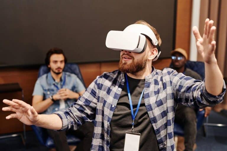 A man wearing a virtual reality headset engages actively in an immersive gaming or virtual experience, demonstrating modern VR technology in a tech-focused environment at GeekExtreme.