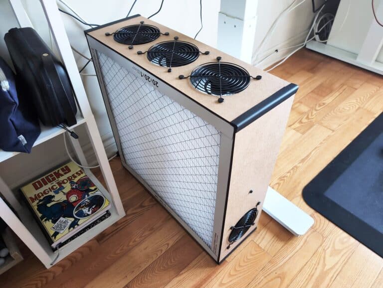 Modern air purifier with three cooling fans on top, designed for efficient air filtration and improved indoor air quality.