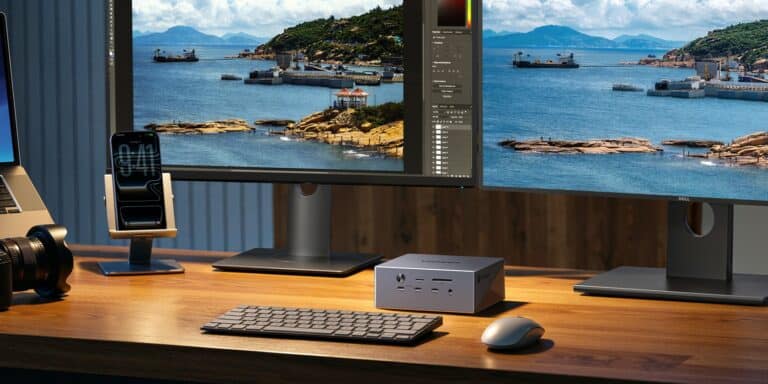 UGREEN Revodock Maxidock Thunderbolt 5 docking station with dual monitors, keyboard, and mouse on a wooden desk, showcasing high-speed connectivity and professional setup.