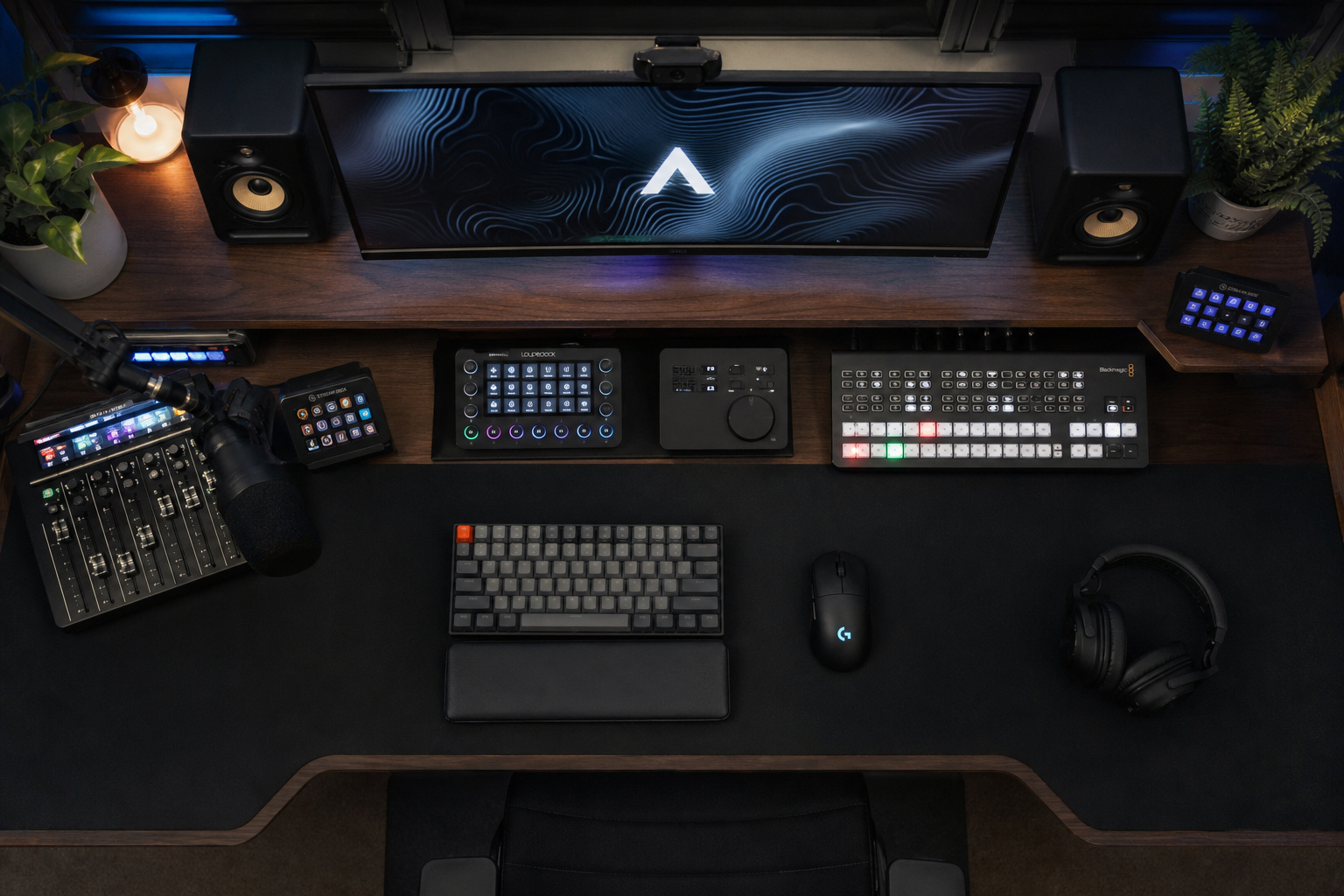 Professional music production studio featuring a computer monitor, MIDI controllers, audio mixer, keyboard, mouse, and headphones for high-quality sound creation.