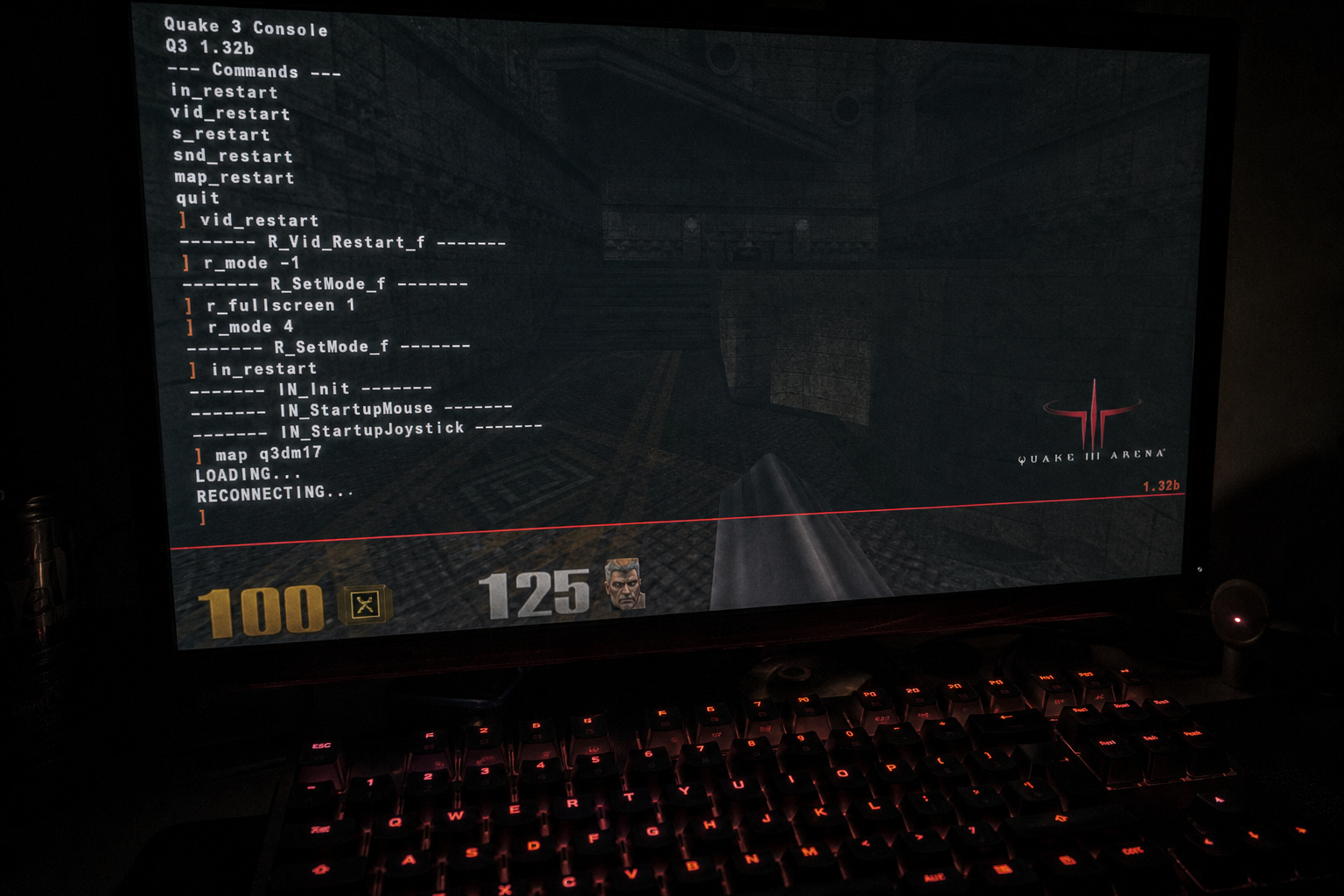 What Is Casual Gaming? From DOS Memory Edits to Candy Crush 4 Laptop screen displaying Quake 3 console commands and gameplay, with a gaming keyboard illuminated in red, capturing a gaming session.