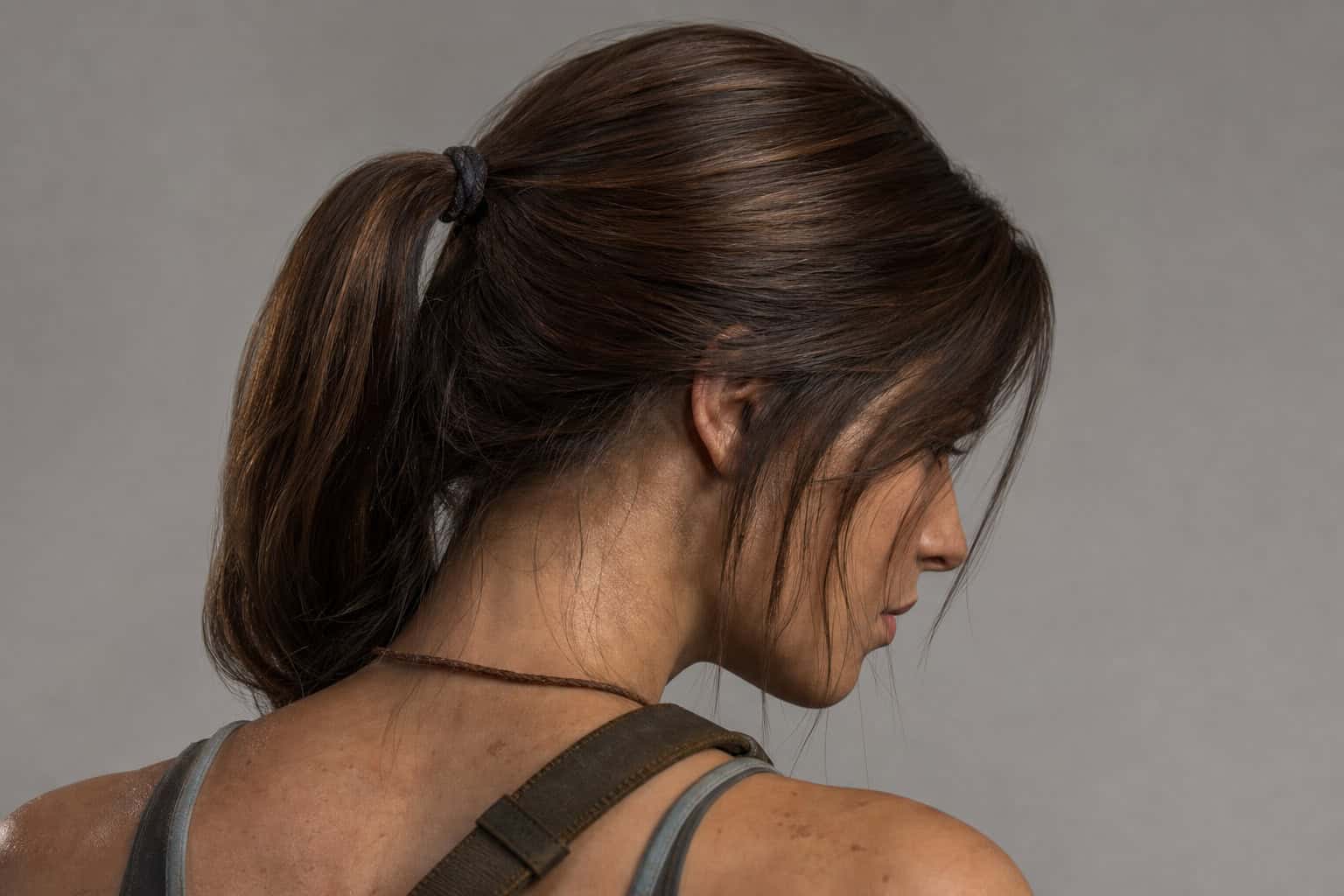 Close-up of Lara Croft's tied-back hair and practical action-ready silhouette.