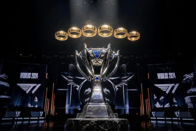 The F1 World Championship trophy displayed on stage at the 2024 race, with rings floating above and large screens in the background showing 'Worlds 2024' and F1 logos.