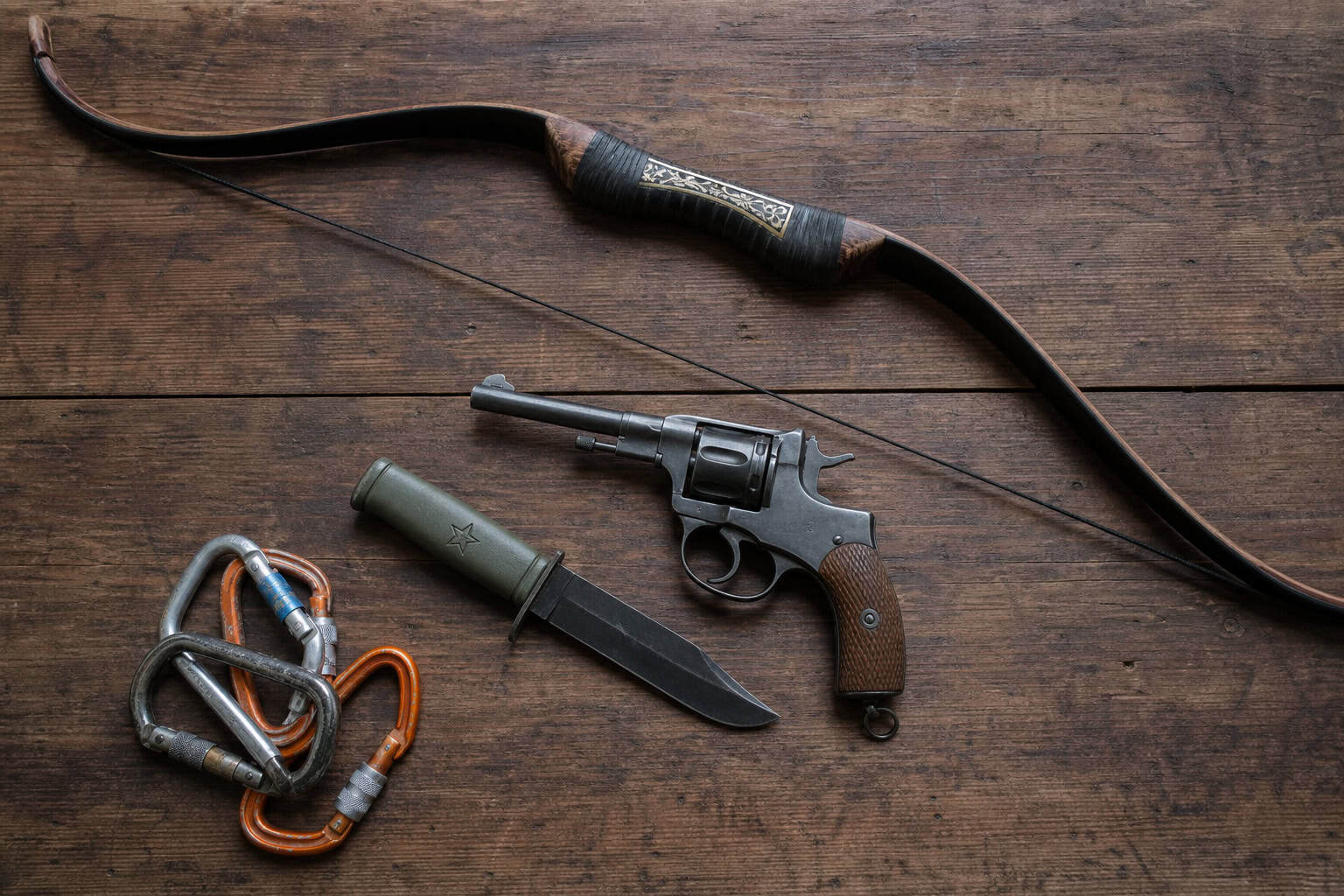 Rise of the Tomb Raider gear including Byzantine recurve bow, Nagant revolver, and Soviet tactical knife.