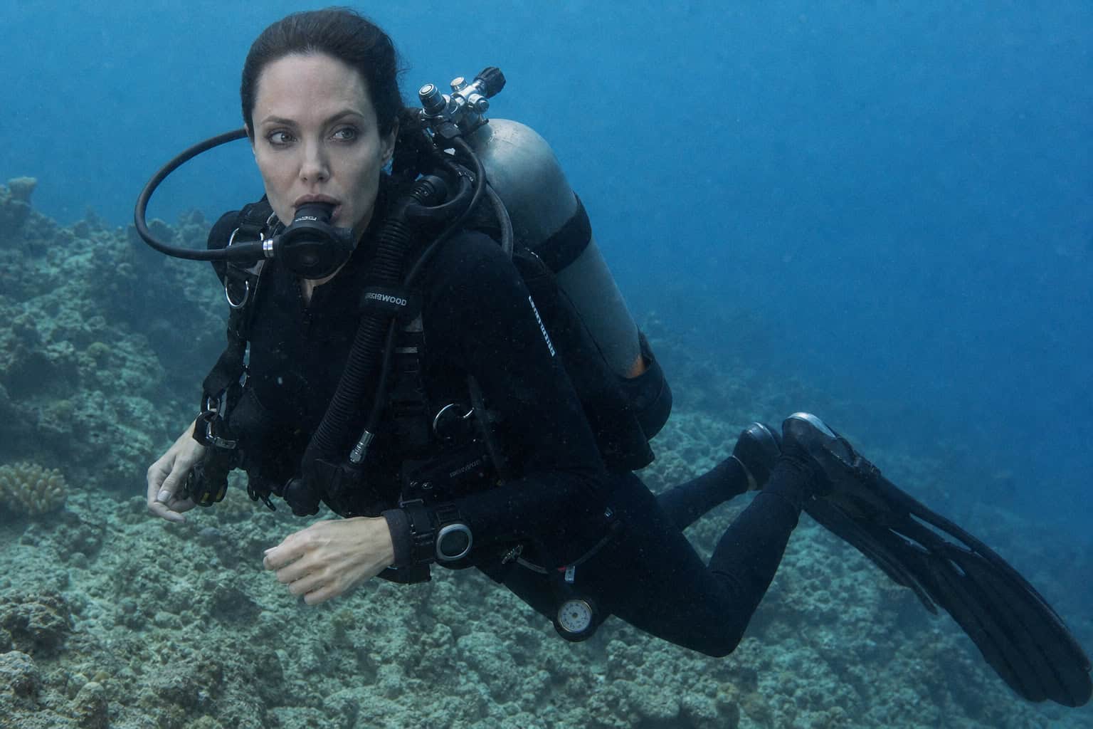 Angelina Jolie wearing full scuba equipment in The Cradle of Life, modular and realistic diving gear.