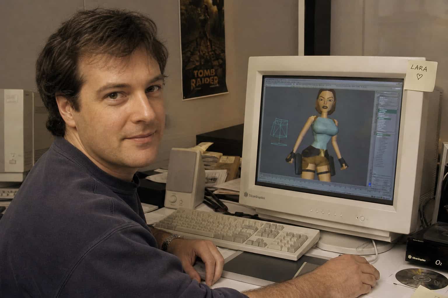 Angelina Jolie's Tomb Raider Costume: The Shorts Controversy and Lindy Hemming's Design 2 Toby Gard at a computer in the 1990s with a low-poly Lara Croft model on screen showing exaggerated proportions.