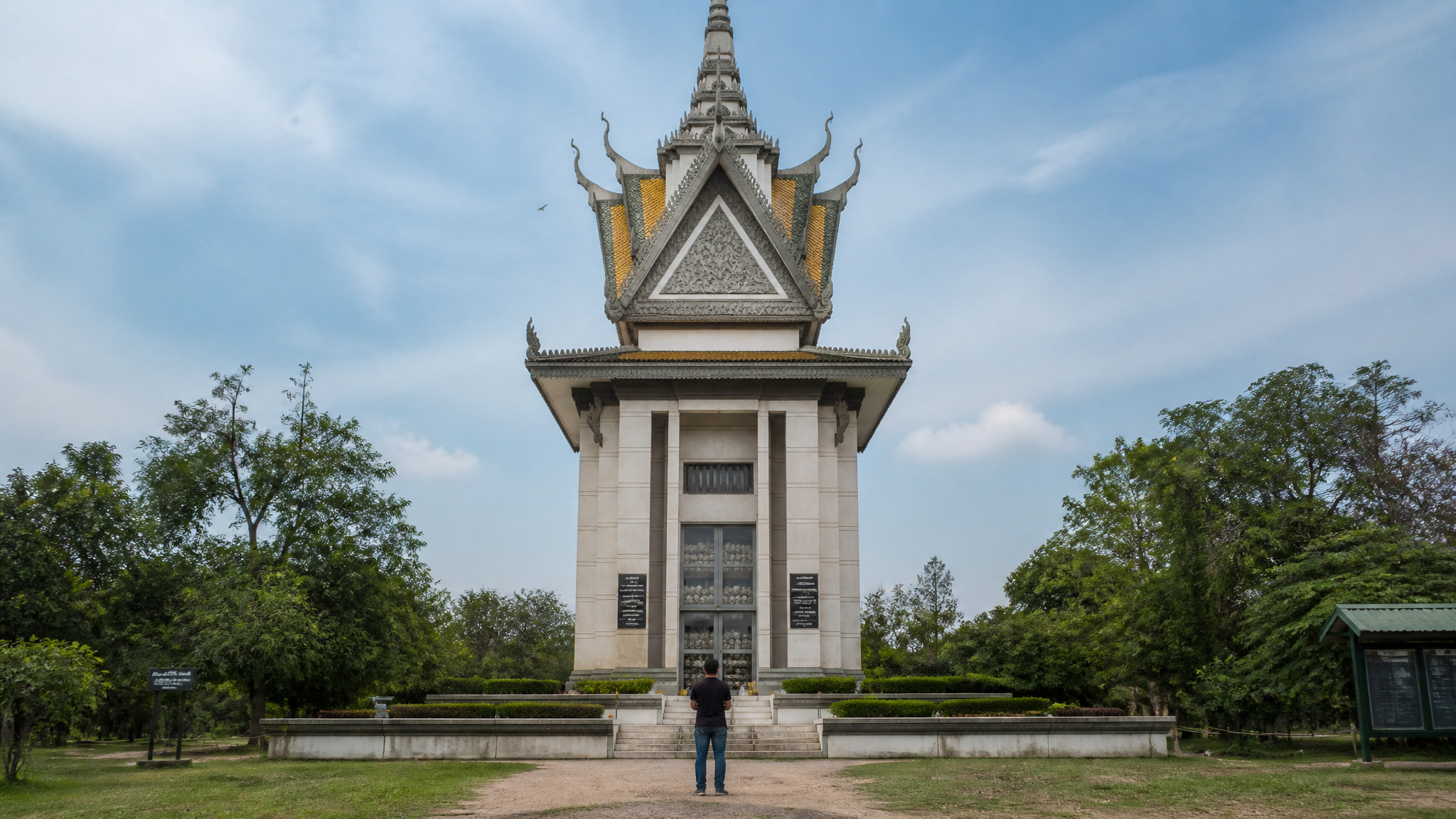 Dark-Tourism Museums: 20 Sites I've Visited That Confront Death 3 Choeung Ek Killing Fields memorial stupa with skulls, a dark tourism site in Cambodia.