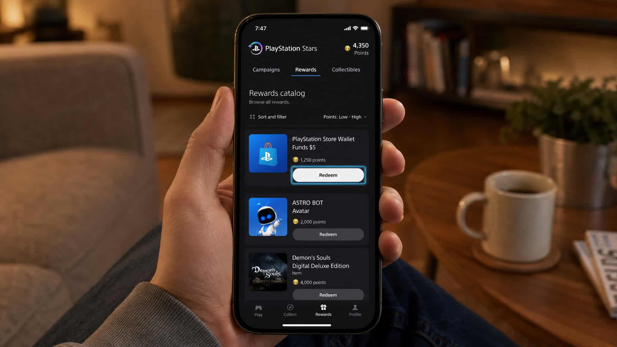 Can I Get a PlayStation for Free? The Honest Answer (With Deadlines) 4 Person holding smartphone showing PlayStation Stars rewards catalog with redeem button