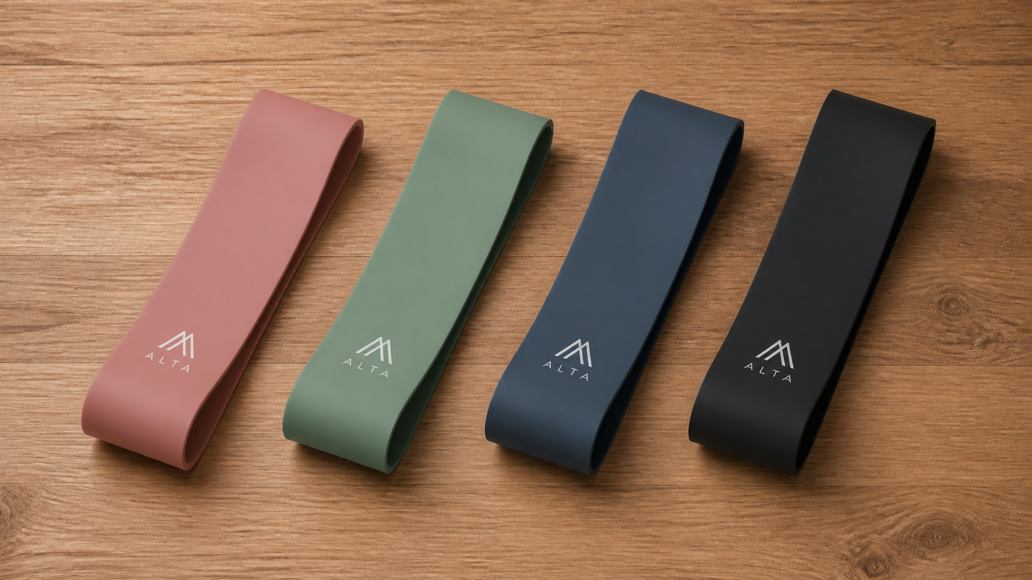 Set of four Altra running shoe insoles in pink, green, blue, and black on wooden surface, designed for comfort and performance.