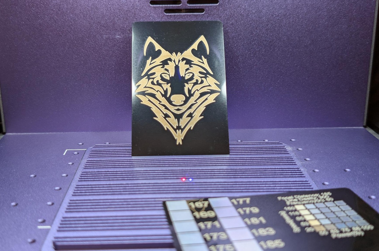 WeCreat Lumos Flex Review: Where the Metal Claims End and MOPA Begins 7 Close-up of GeekExtreme Lumos Flex LED light with wolf logo, showcasing sleek design and adjustable brightness features.