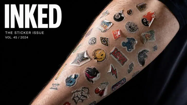 Close-up of a forearm with various colorful tattoo stickers including smiley faces, lightning bolts, and comic book icons, showcasing a vibrant tattoo sticker collection.
