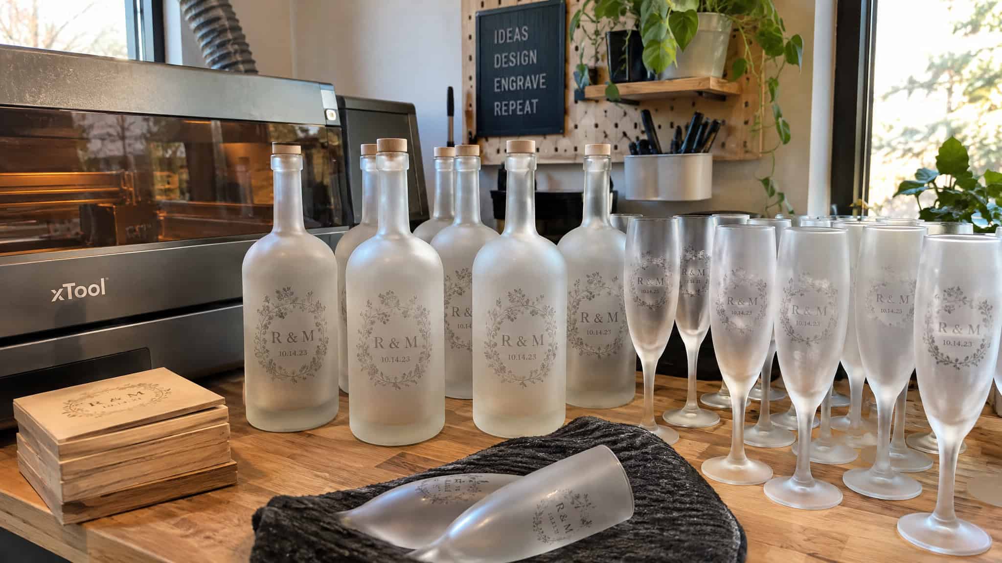 Laser Engraving on Glass Bottles: The Rotary Setup, Settings, and Placement Rules Most Beginners Miss 4 Batch of finished laser engraved glass bottles and flutes from a small business order