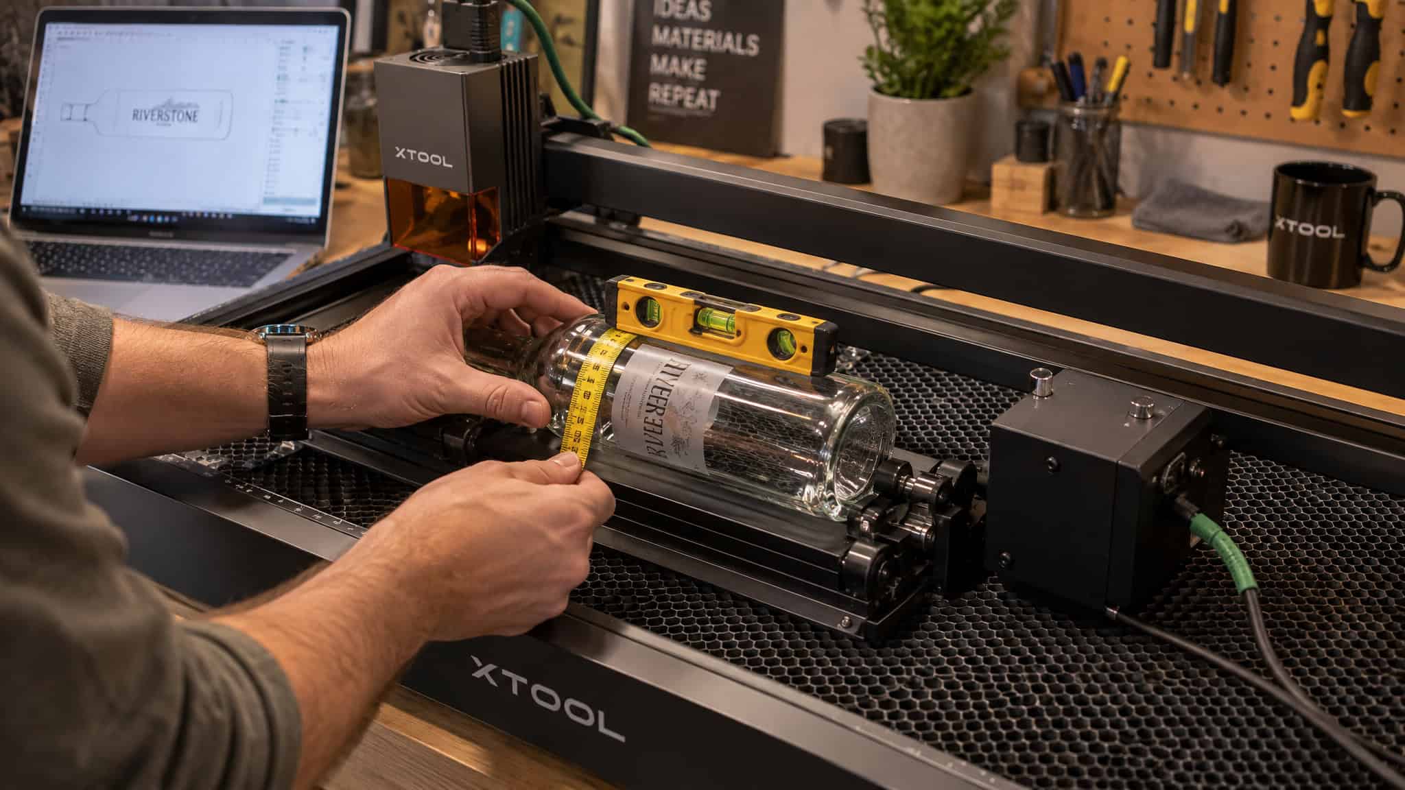 Laser Engraving on Glass Bottles: The Rotary Setup, Settings, and Placement Rules Most Beginners Miss 3 Calibrating a laser rotary with a bubble level and measuring bottle circumference at the engraving band