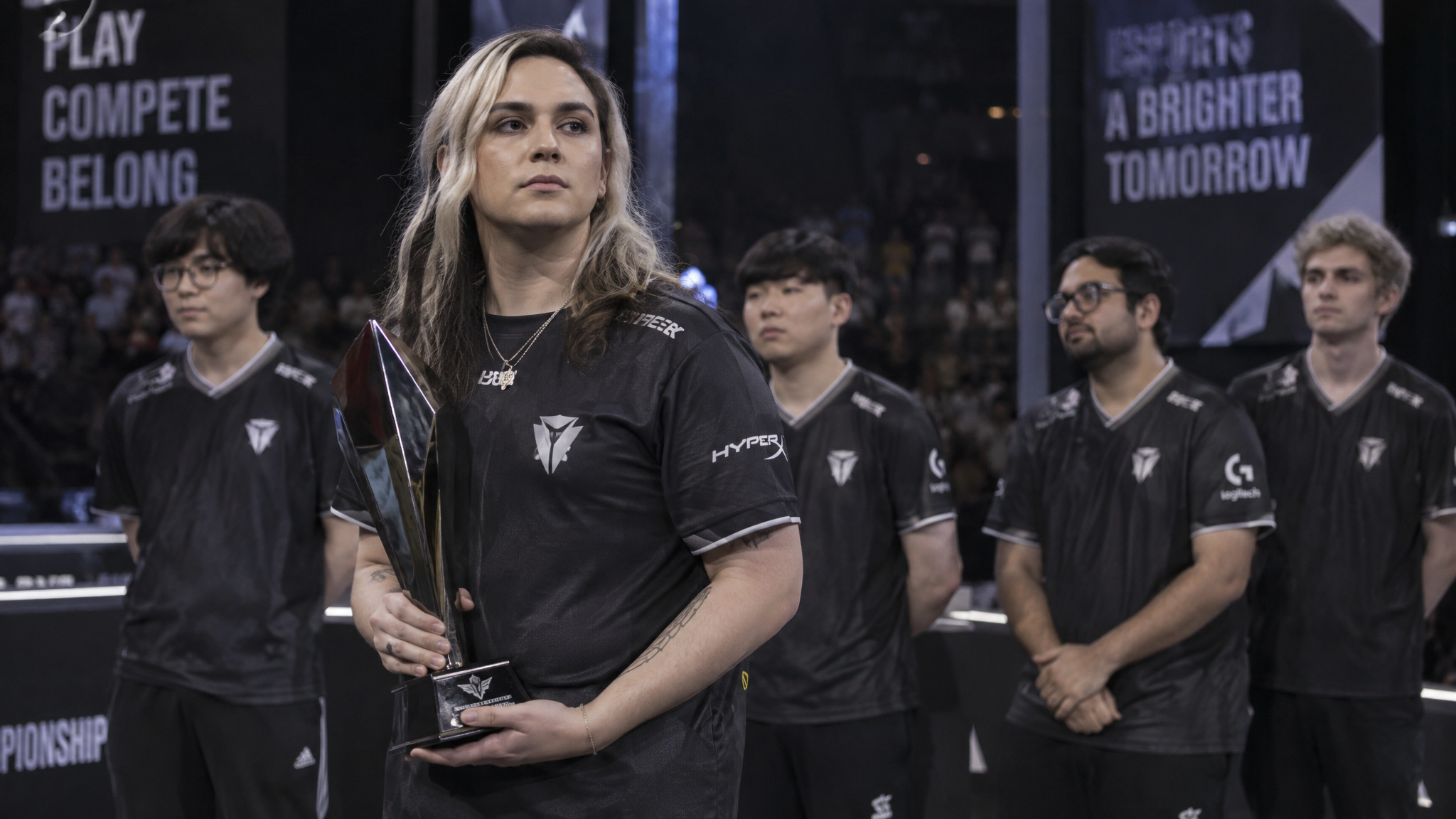 What Does Female Esports Mean? The IeSF 2014 Reversal and the 35%/5% Gap 4 Trans esports player holding a trophy at a women's tournament amid the eligibility boundary dispute